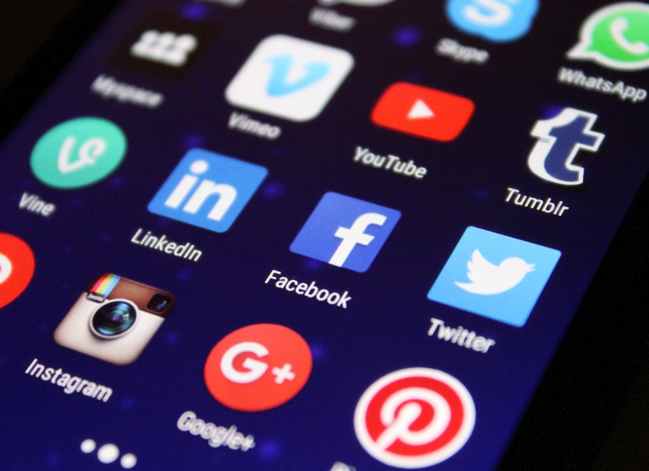 gallery-2 Close-up of a smartphone screen showing various social media app icons such as Facebook and Twitter.
